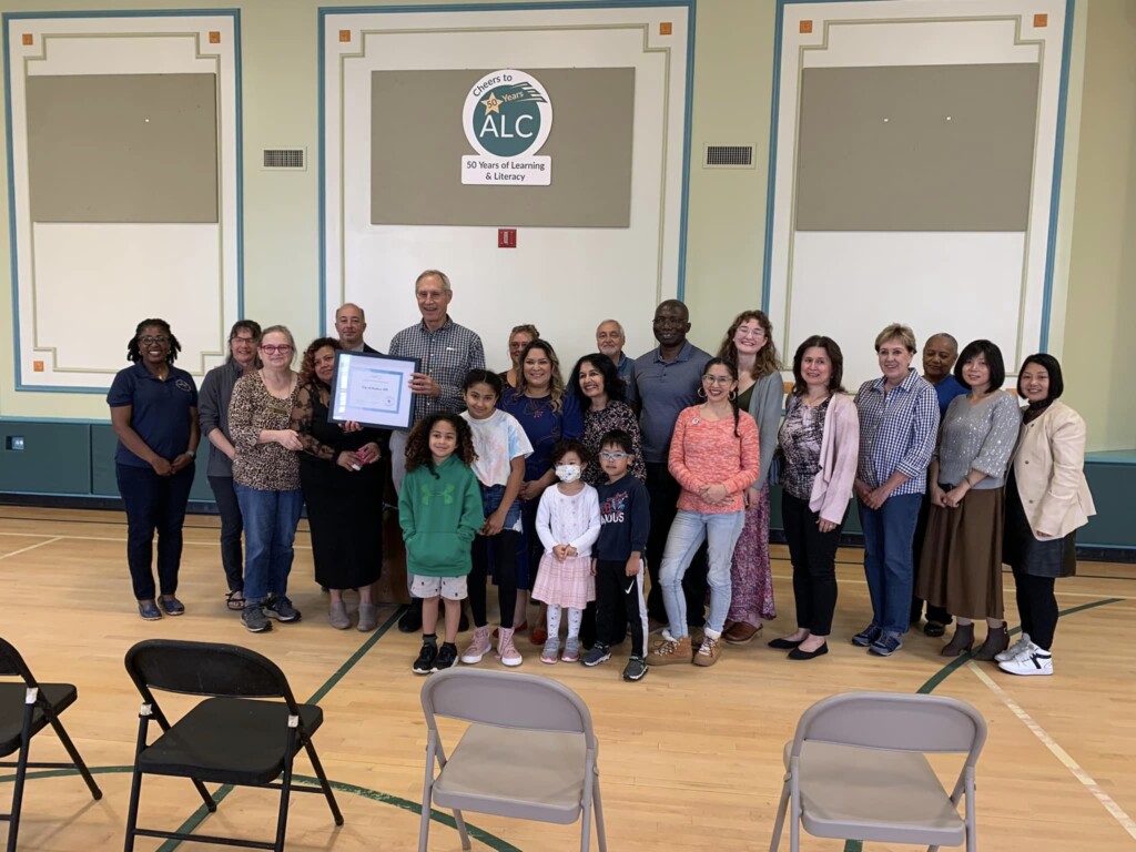 Group of people gathers together to celebrate Certified Welcoming designation of Nashua, NH